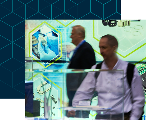Two attendees examining products in the expo hall floor