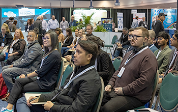 A diverse audience seated in rows of chairs, participating in MEDevice Silicon Valley theater