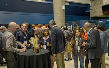 Attendees standing around tables, interacting and networking at MEDevice Silicon Valley